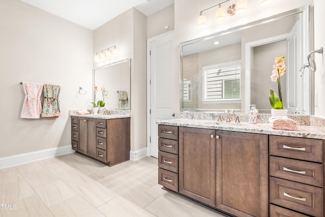 192 Glenpark Pl, Cary, NC 27511 - full bathroom featuring two vanities, tiled shower, and baseboards