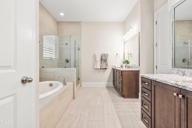 192 Glenpark Pl, Cary, NC 27511 - full bath with a stall shower, two vanities, a bath, and recessed lighting
