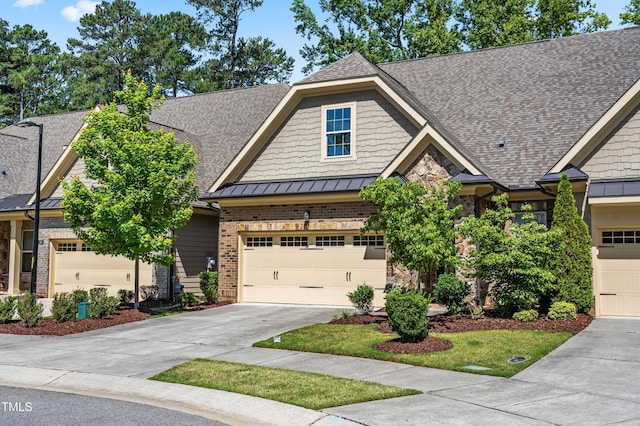 192 Glenpark Pl, Cary, NC 27511 - craftsman inspired home featuring a standing seam roof, concrete driveway, roof with shingles, metal roof, and stone siding