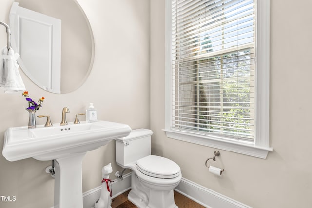 192 Glenpark Pl, Cary, NC 27511 - half bathroom featuring plenty of natural light, toilet, baseboards, and wood finished floors