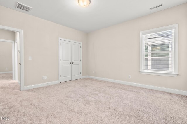 192 Glenpark Pl, Cary, NC 27511 - unfurnished bedroom with carpet, baseboards, and a closet