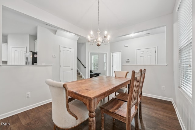 68 Holly Berry Ln, Durham, NC 27703 - dining area with stairway, a chandelier, dark wood-type flooring, and baseboards