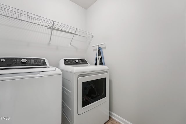 68 Holly Berry Ln, Durham, NC 27703 - washroom featuring washer and clothes dryer and baseboards