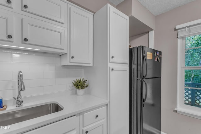 501 Gooseneck Dr Unit B2, Cary, NC 27513 - kitchen with freestanding refrigerator, a sink, white cabinets, and backsplash