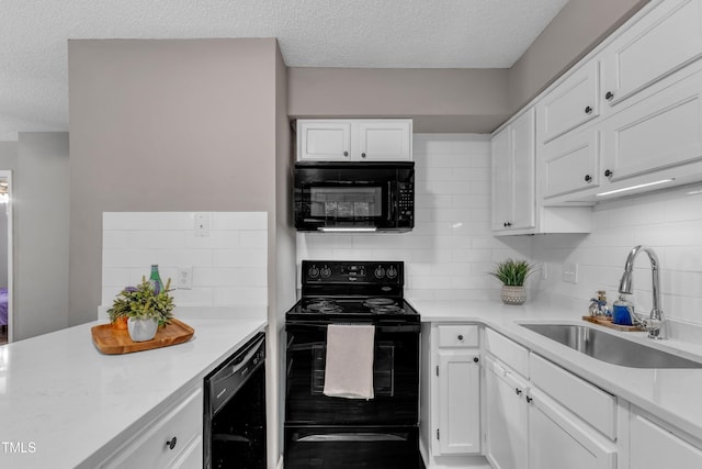 501 Gooseneck Dr Unit B2, Cary, NC 27513 - kitchen featuring black appliances, a sink, a textured ceiling, backsplash, and white cabinetry