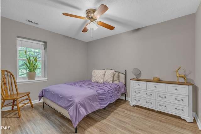 501 Gooseneck Dr Unit B2, Cary, NC 27513 - bedroom featuring light wood-type flooring, baseboards, and a textured ceiling