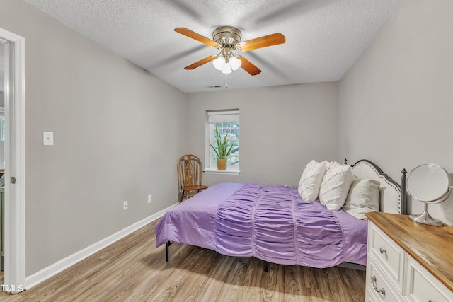 501 Gooseneck Dr Unit B2, Cary, NC 27513 - bedroom featuring light wood-style flooring, a textured ceiling, baseboards, and ceiling fan
