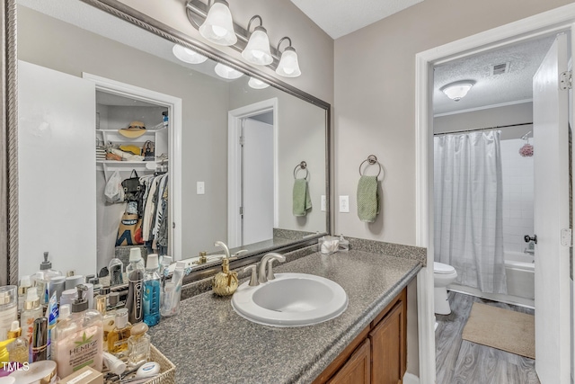 501 Gooseneck Dr Unit B2, Cary, NC 27513 - full bathroom featuring toilet, vanity, shower / bathtub combination with curtain, a walk in closet, and wood finished floors