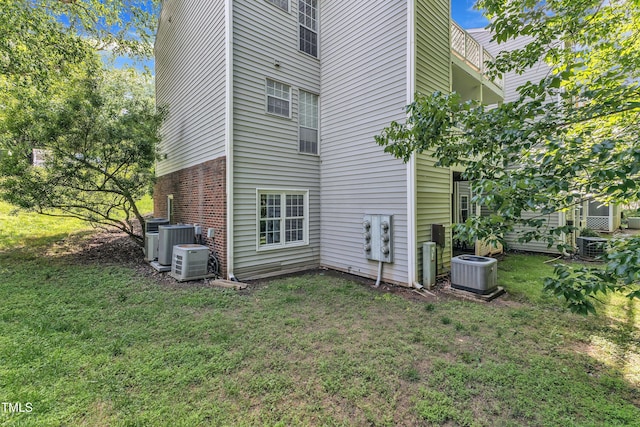 501 Gooseneck Dr Unit B2, Cary, NC 27513 - back of house featuring central AC unit, a yard, and brick siding