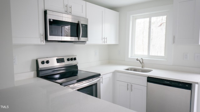 800 Pritchard Avenue Extension Unit H4, Chapel Hill, NC 27516 - kitchen with appliances with stainless steel finishes, a sink, white cabinets, and light countertops
