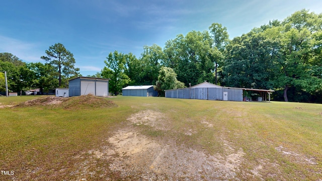 4509 Stevens Chapel Rd, Smithfield, NC 27577 - view of green lawn featuring a detached garage, a pole building, and an outbuilding