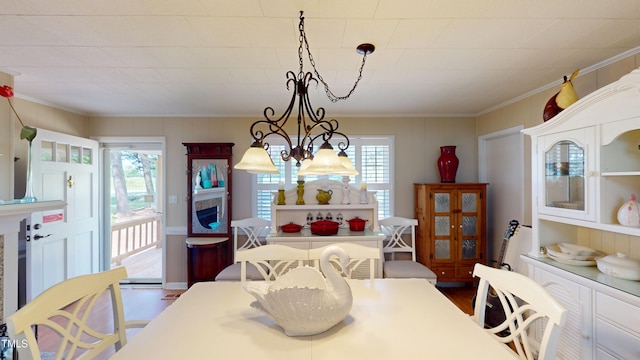 4509 Stevens Chapel Rd, Smithfield, NC 27577 - dining space with a chandelier, plenty of natural light, dark wood-type flooring, and crown molding