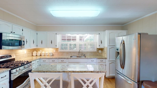 4509 Stevens Chapel Rd, Smithfield, NC 27577 - kitchen with stainless steel appliances, a sink, white cabinetry, backsplash, and light stone counters