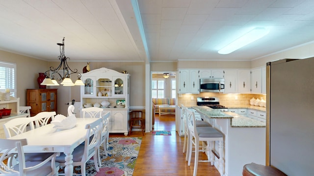 4509 Stevens Chapel Rd, Smithfield, NC 27577 - dining area with ornamental molding, light wood-type flooring, and ceiling fan