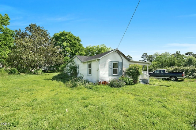 441 Cedar St, Henderson, NC 27536 - view of property exterior with a lawn