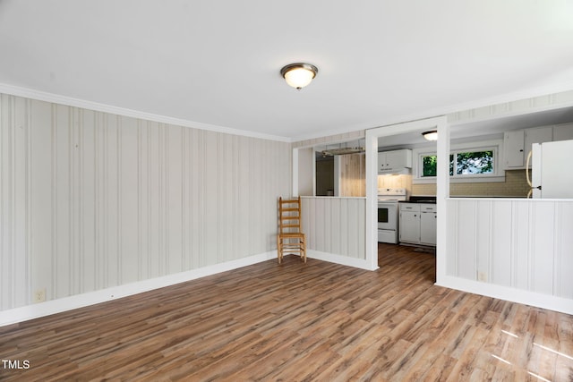 441 Cedar St, Henderson, NC 27536 - unfurnished living room featuring ornamental molding, wood finished floors, and baseboards