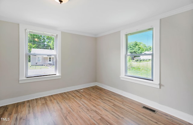 441 Cedar St, Henderson, NC 27536 - empty room with healthy amount of natural light, ornamental molding, light wood-style floors, and baseboards
