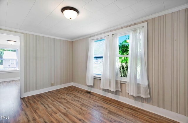 441 Cedar St, Henderson, NC 27536 - unfurnished room featuring ornamental molding, wood finished floors, baseboards, healthy amount of natural light, and wallpapered walls