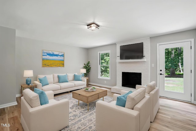 3916 W Allen, Raleigh, NC 27603 - living room featuring light wood-style flooring, a fireplace, and baseboards