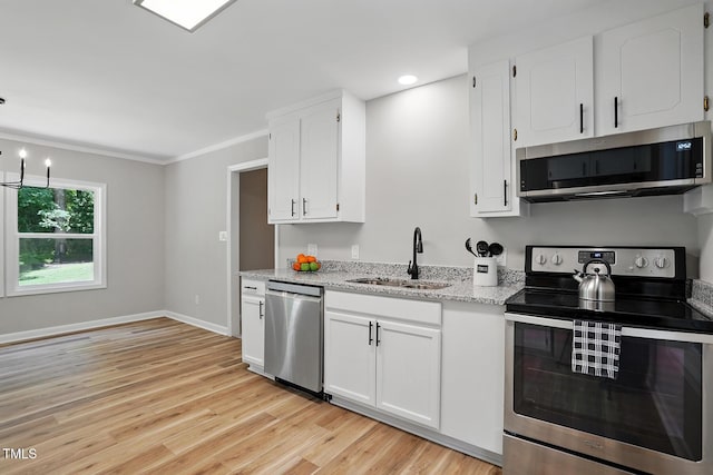 3916 W Allen, Raleigh, NC 27603 - kitchen with stainless steel appliances, a sink, white cabinetry, light wood finished floors, and light stone counters