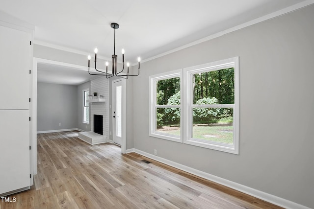 3916 W Allen, Raleigh, NC 27603 - unfurnished living room featuring baseboards, a chandelier, light wood-style floors, crown molding, and a fireplace