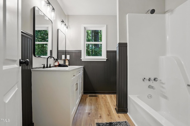 3916 W Allen, Raleigh, NC 27603 - bathroom featuring a wainscoted wall, vanity, shower / tub combination, and wood finished floors