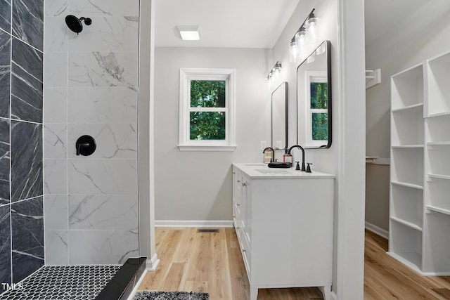 3916 W Allen, Raleigh, NC 27603 - full bathroom featuring vanity, a tile shower, and wood finished floors