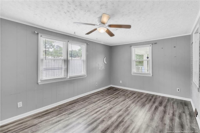 5409 S Sumac Cir, Fayetteville, NC 28304 - empty room featuring plenty of natural light, wood finished floors, a textured ceiling, crown molding, and baseboards
