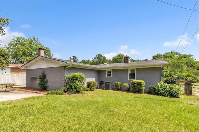 5409 S Sumac Cir, Fayetteville, NC 28304 - view of front of home featuring a chimney, central air condition unit, brick siding, and a patio area