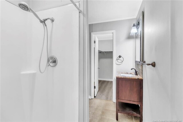 5409 S Sumac Cir, Fayetteville, NC 28304 - bathroom featuring a shower, vanity, ornamental molding, and tile patterned floors