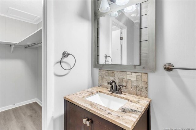 5409 S Sumac Cir, Fayetteville, NC 28304 - bathroom featuring wood finished floors, vanity, backsplash, and baseboards