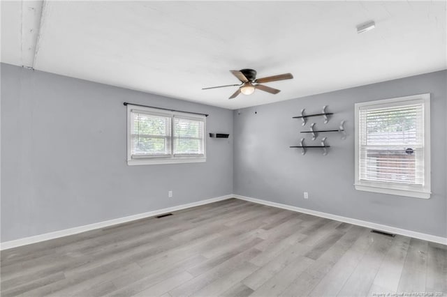 5409 S Sumac Cir, Fayetteville, NC 28304 - empty room featuring plenty of natural light, wood finished floors, and a ceiling fan