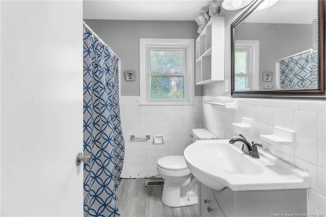 5409 S Sumac Cir, Fayetteville, NC 28304 - full bath with tile walls, toilet, vanity, wood finished floors, and a wainscoted wall