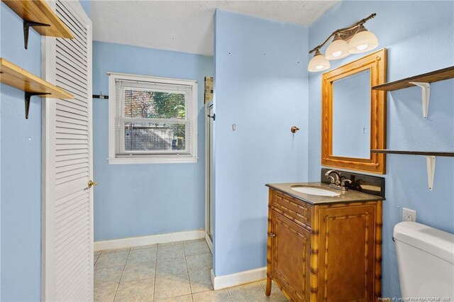 5409 S Sumac Cir, Fayetteville, NC 28304 - bathroom with a stall shower, toilet, tile patterned floors, baseboards, and vanity
