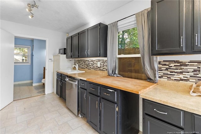 5409 S Sumac Cir, Fayetteville, NC 28304 - kitchen featuring dishwasher, a sink, decorative backsplash, and baseboards