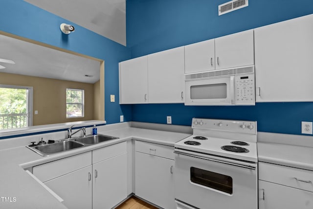 5134 Greenville Loop Rd Apt D, Wilmington, NC 28409 - kitchen featuring white appliances, a sink, light countertops, and white cabinetry