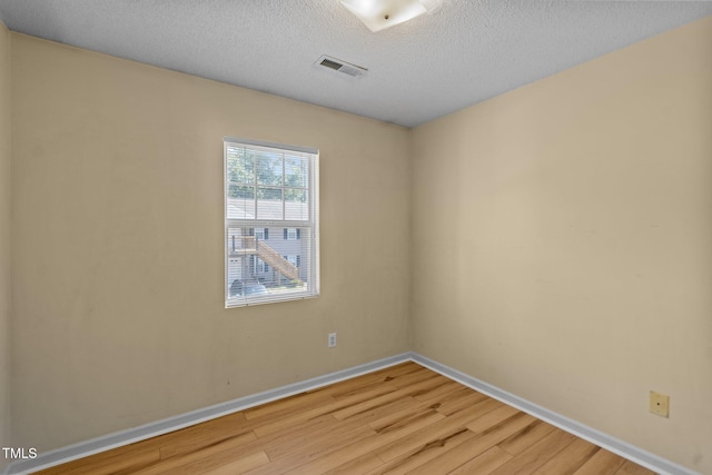 5134 Greenville Loop Rd Apt D, Wilmington, NC 28409 - empty room featuring light wood-type flooring, baseboards, and a textured ceiling