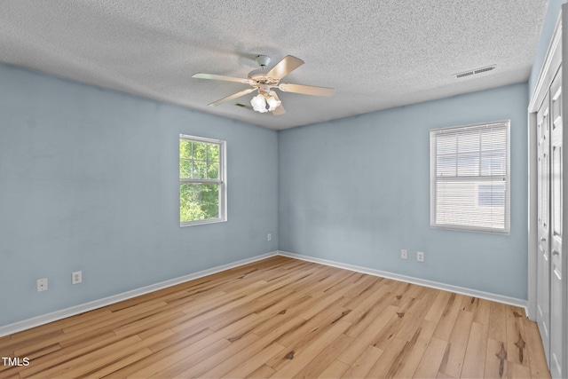 5134 Greenville Loop Rd Apt D, Wilmington, NC 28409 - spare room featuring light wood-style floors, a textured ceiling, ceiling fan, and baseboards