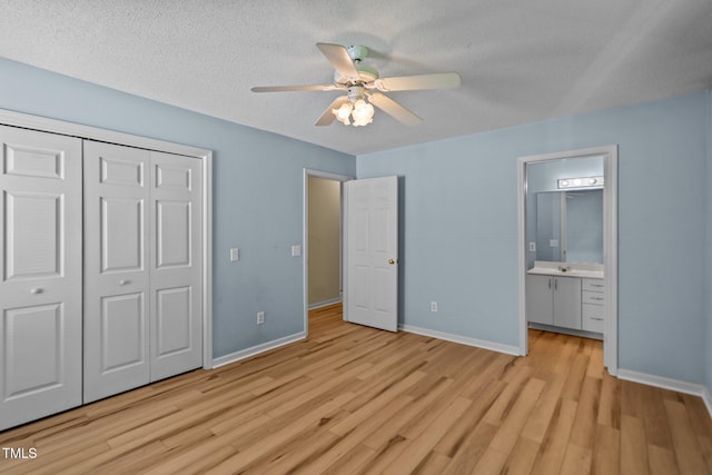 5134 Greenville Loop Rd Apt D, Wilmington, NC 28409 - unfurnished bedroom featuring light wood-style flooring, a closet, baseboards, a textured ceiling, and ensuite bathroom