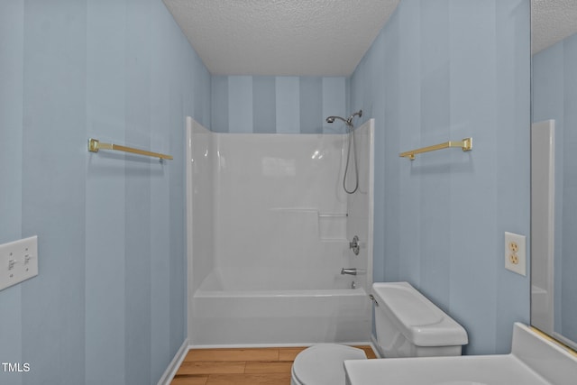 5134 Greenville Loop Rd Apt D, Wilmington, NC 28409 - bathroom featuring a textured ceiling, toilet, wood finished floors, shower / tub combination, and vanity