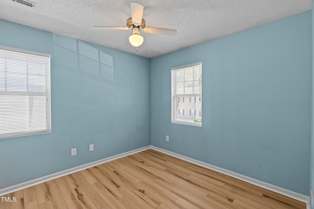 5134 Greenville Loop Rd Apt D, Wilmington, NC 28409 - unfurnished room with wood finished floors, a textured ceiling, ceiling fan, and baseboards
