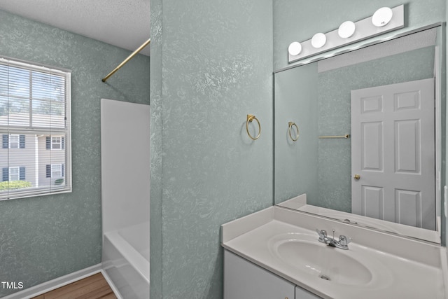 5134 Greenville Loop Rd Apt D, Wilmington, NC 28409 - full bath with wood finished floors, vanity, washtub / shower combination, and baseboards