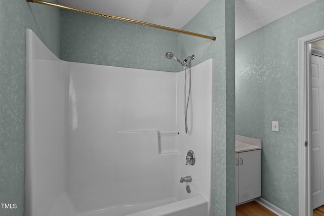 5134 Greenville Loop Rd Apt D, Wilmington, NC 28409 - bathroom with shower / bathtub combination, a textured wall, wood finished floors, and vanity