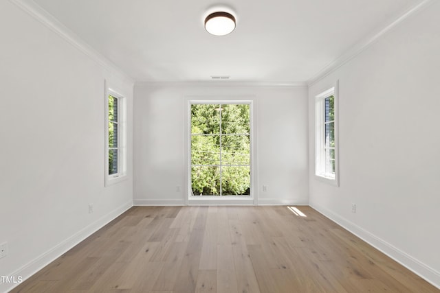 2805 Van Dyke Ave, Raleigh, NC 27607 - spare room featuring crown molding, light wood-type flooring, and baseboards