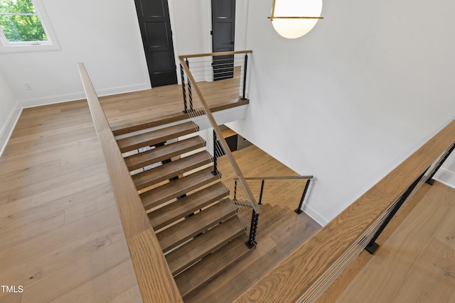 2805 Van Dyke Ave, Raleigh, NC 27607 - staircase with baseboards and wood finished floors