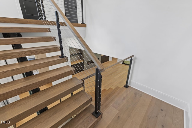 2805 Van Dyke Ave, Raleigh, NC 27607 - staircase with baseboards and wood finished floors