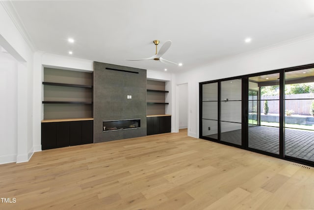 2805 Van Dyke Ave, Raleigh, NC 27607 - unfurnished living room with ornamental molding, light wood-type flooring, built in shelves, a ceiling fan, and baseboards