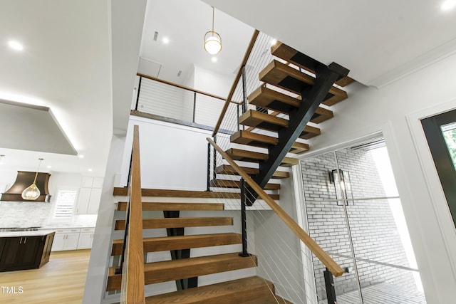2805 Van Dyke Ave, Raleigh, NC 27607 - stairs with plenty of natural light, wood finished floors, and a towering ceiling