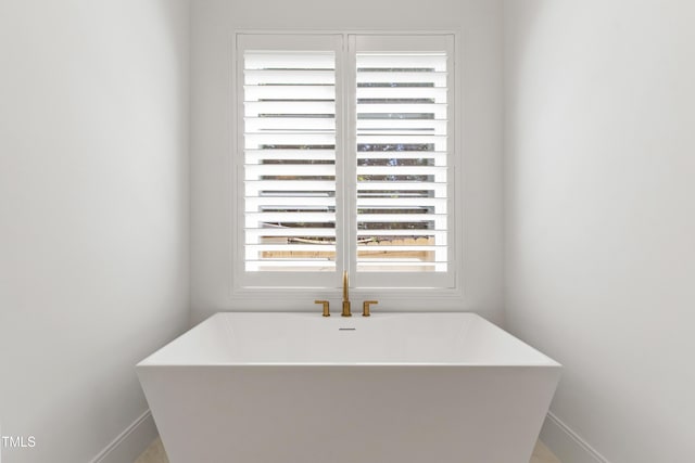 2805 Van Dyke Ave, Raleigh, NC 27607 - full bathroom with a freestanding tub and baseboards