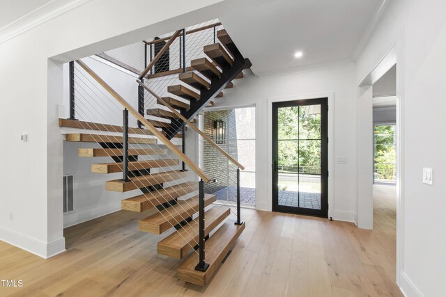 2805 Van Dyke Ave, Raleigh, NC 27607 - foyer with baseboards, stairs, light wood finished floors, crown molding, and recessed lighting